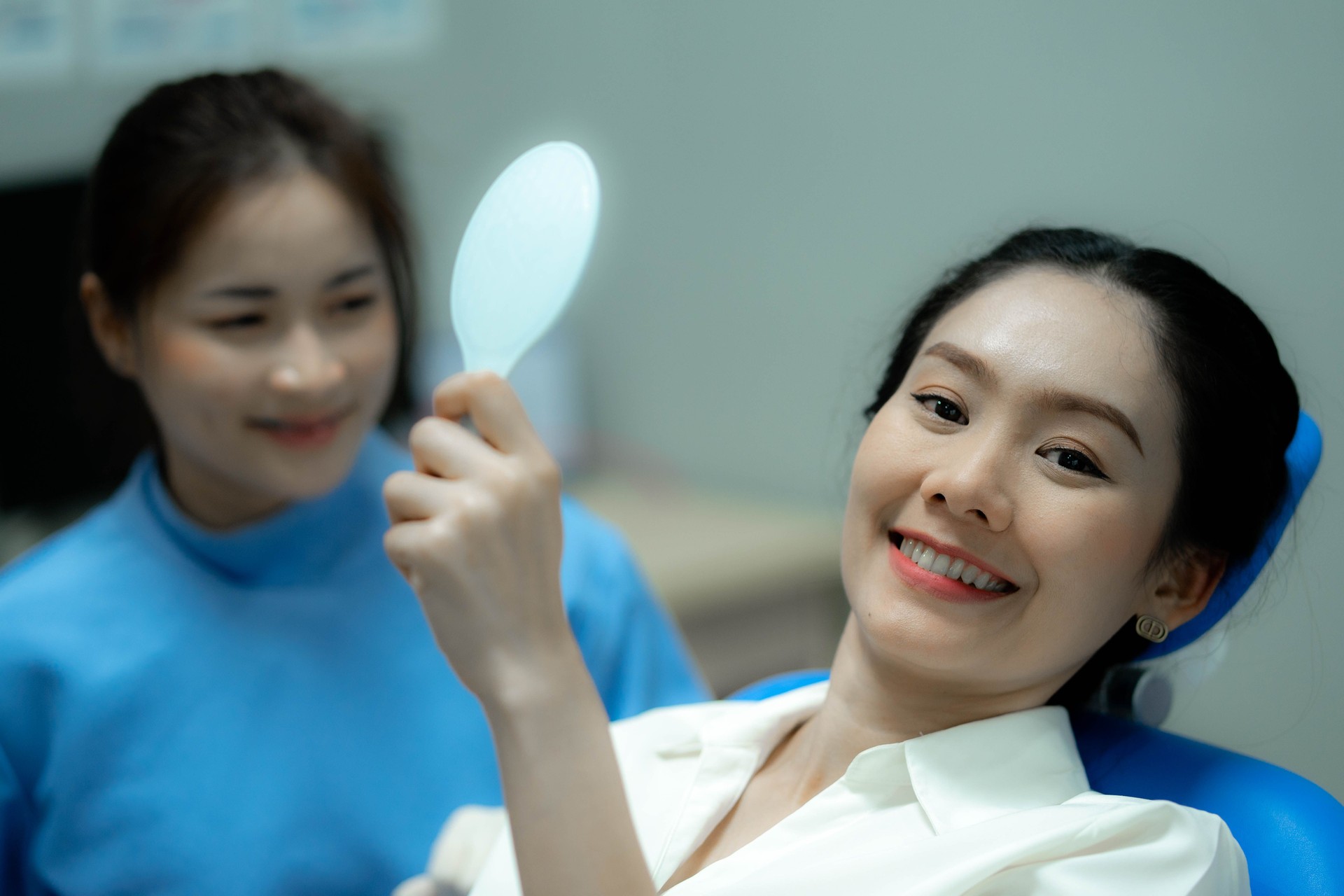 Woman looking at her teeth. Smiling lady at dentist office.