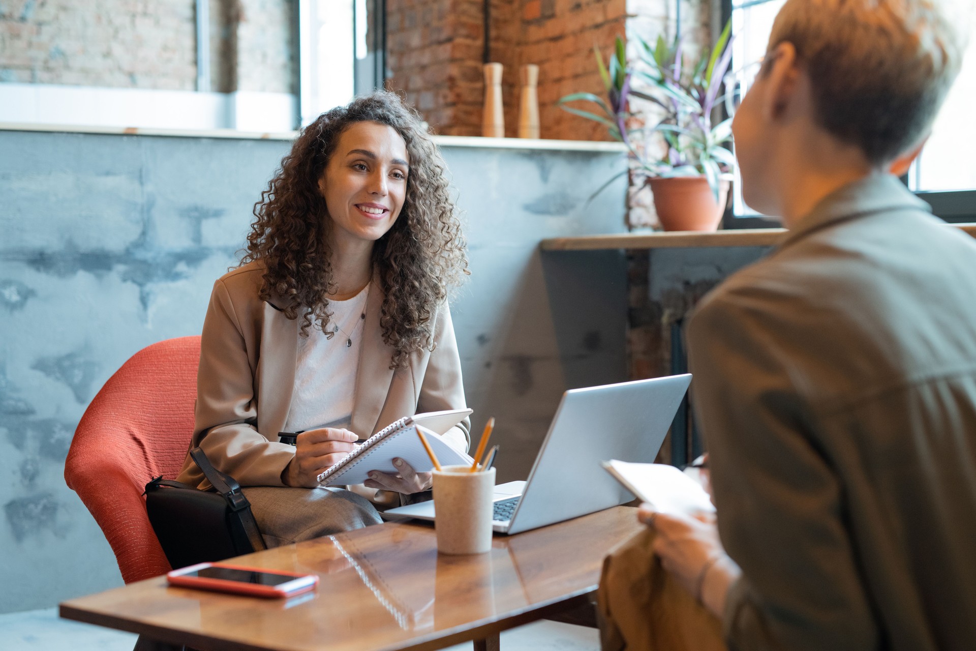 Happy businesswoman looking at colleague